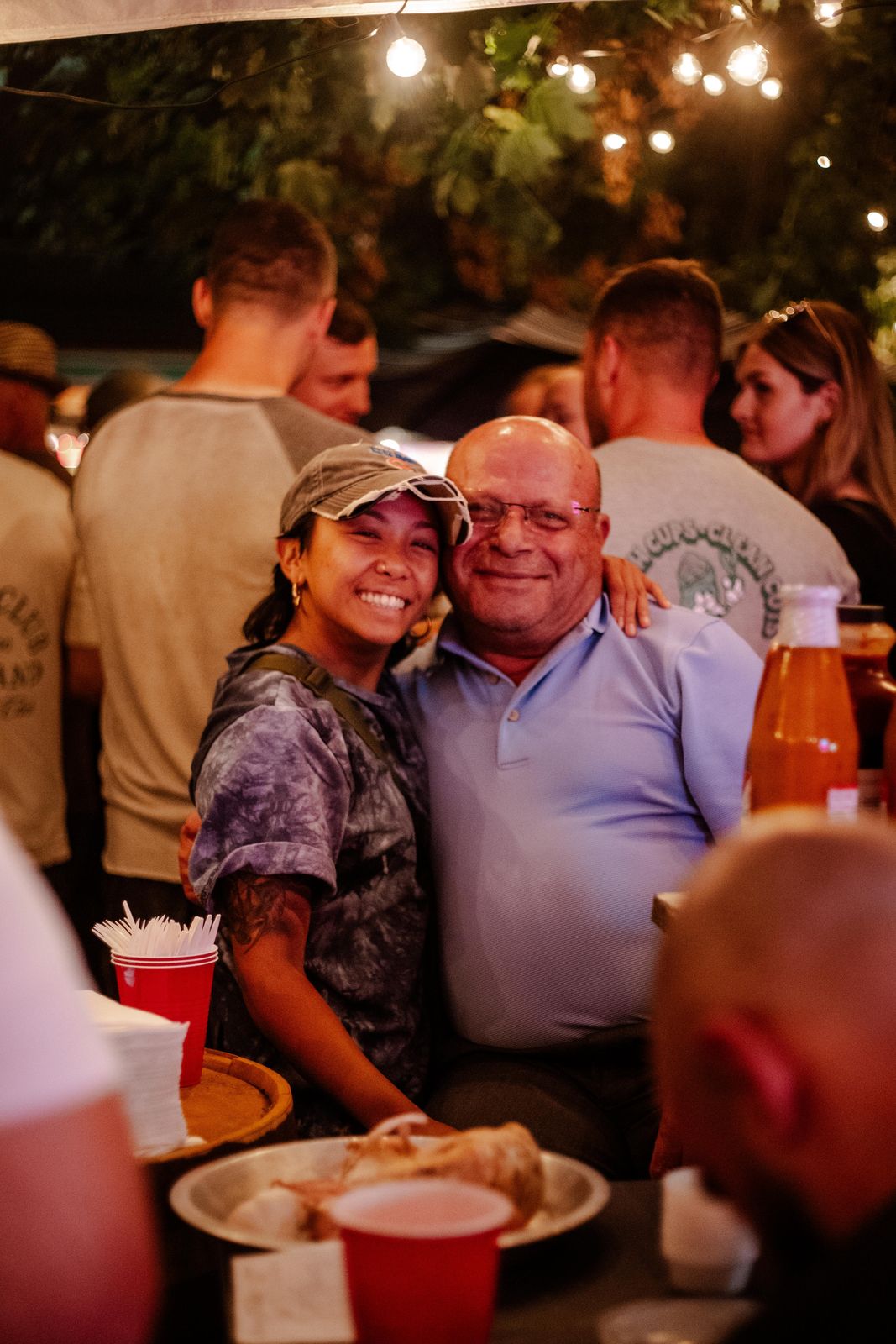 Two guests hugging and smiling at Art Crawl