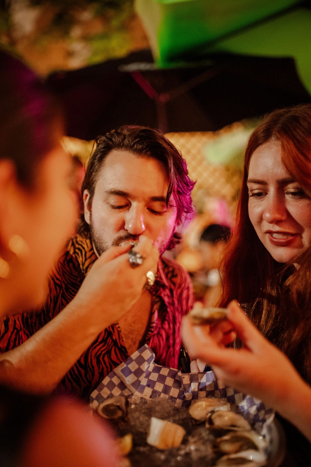 Friends sharing oysters at Art Crawl