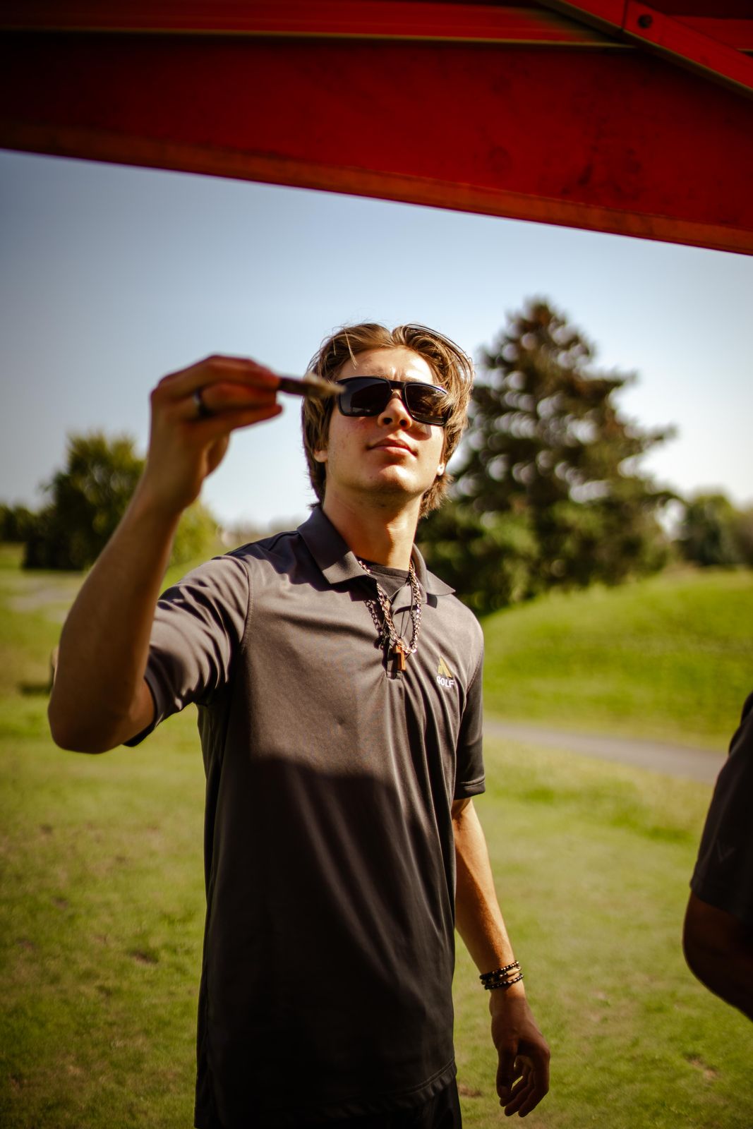 A golfer slurping an oyster on the course at a golf tournament