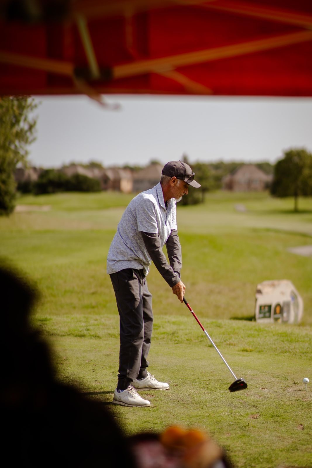 A golfer teeing off at a golf tournament we catered