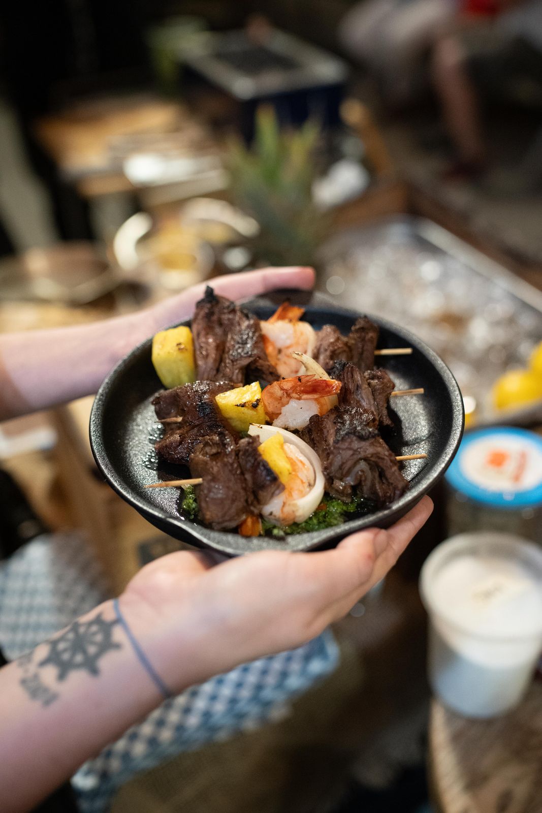 A bowl of grilled seafood handed out at a supper club