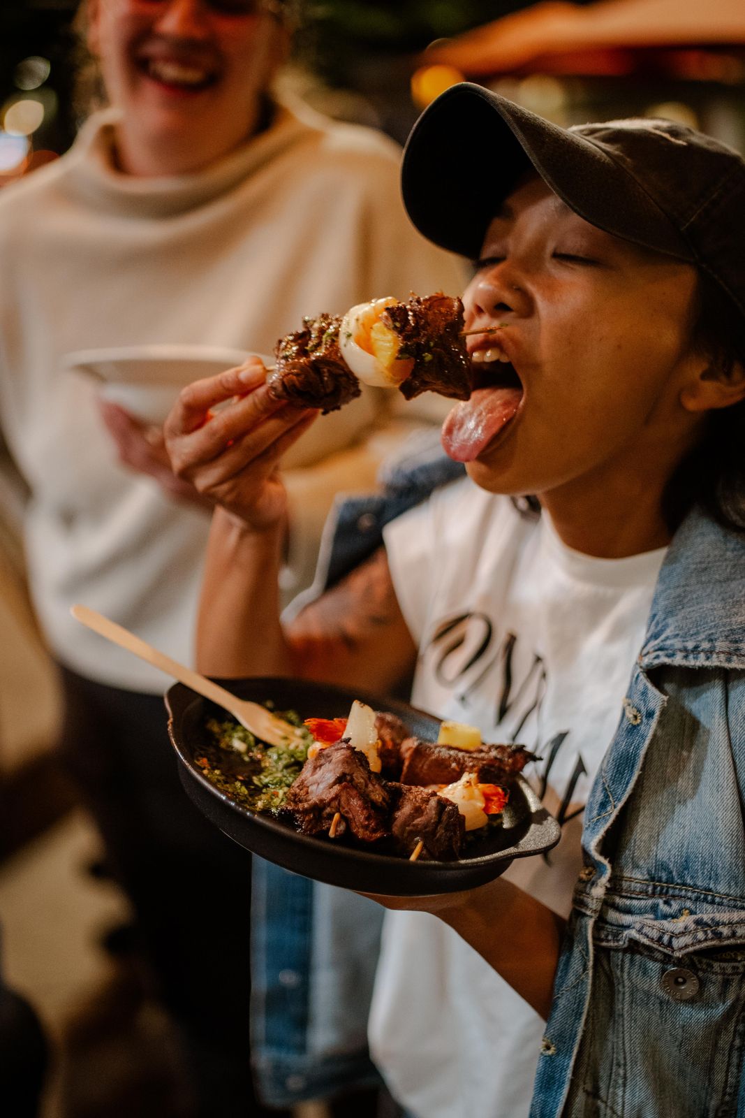 A guest taking a big bite at a supper club