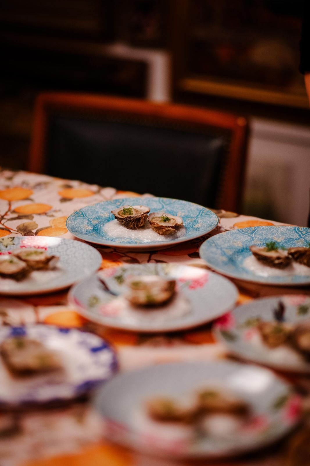 An oyster course plated down a long dinner table
