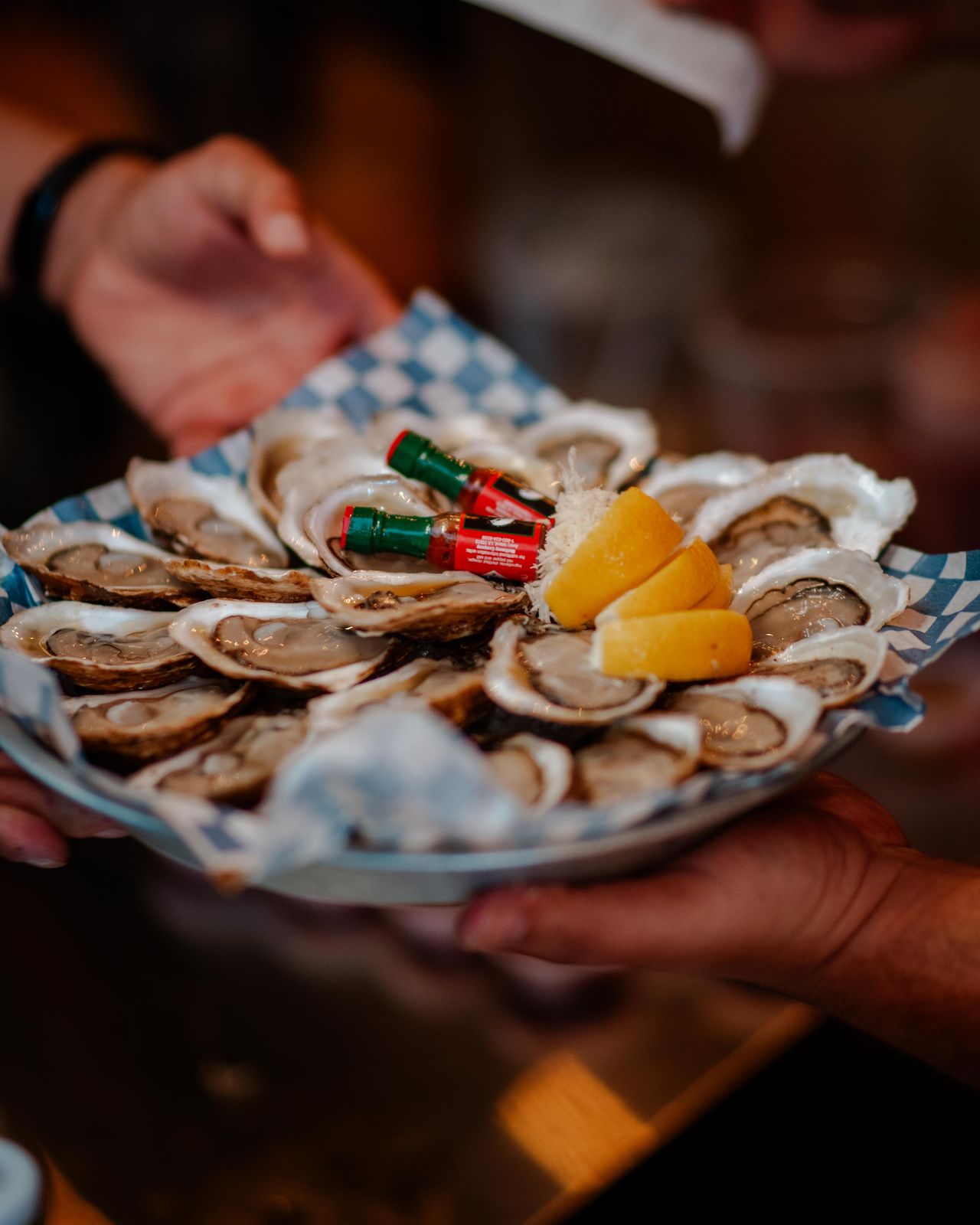 A platter of oysters and lemons carried through the crowd at Supercrawl