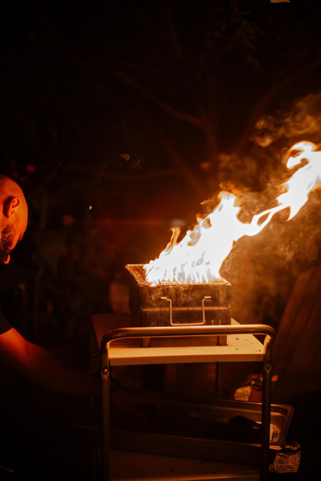 Flames from the grill at a private dinner