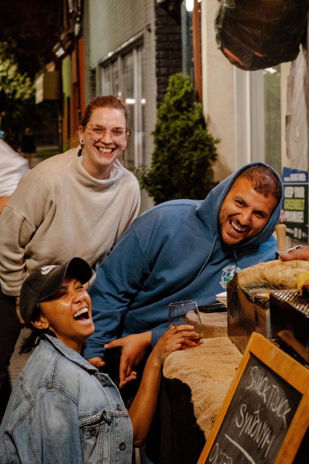 Guests laughing over food at Something Special Club