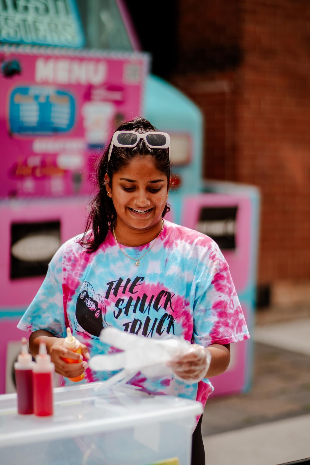Serving in a tie-dye Shuck Truck shirt at Sundays Unlocked