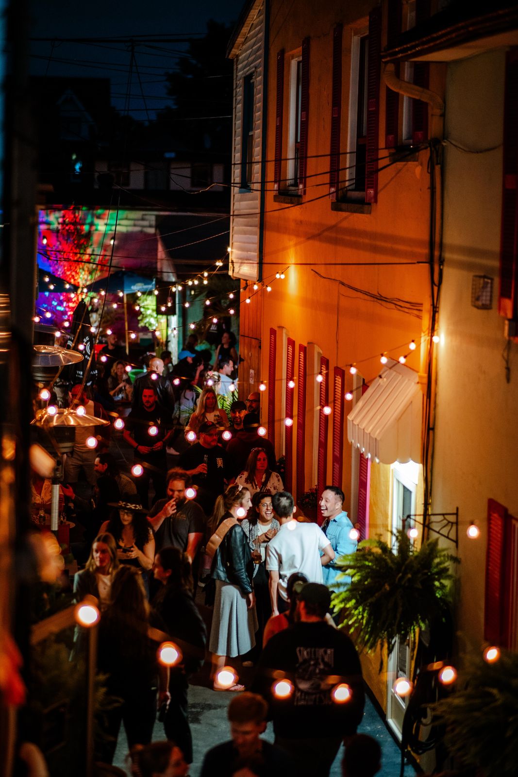 A packed alley at Supercrawl in Hamilton, strung with lights at night