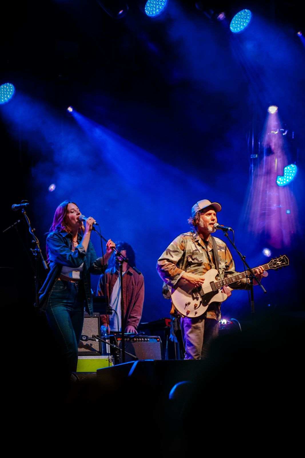 A band on stage under blue lights at Supercrawl