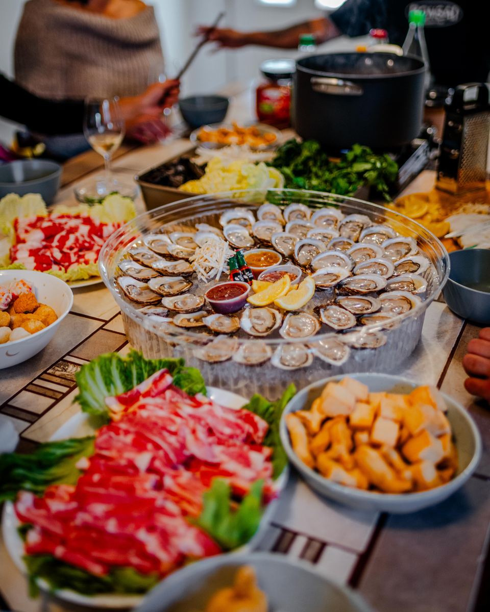 Overhead of the platter surrounded by plates at a family dinner