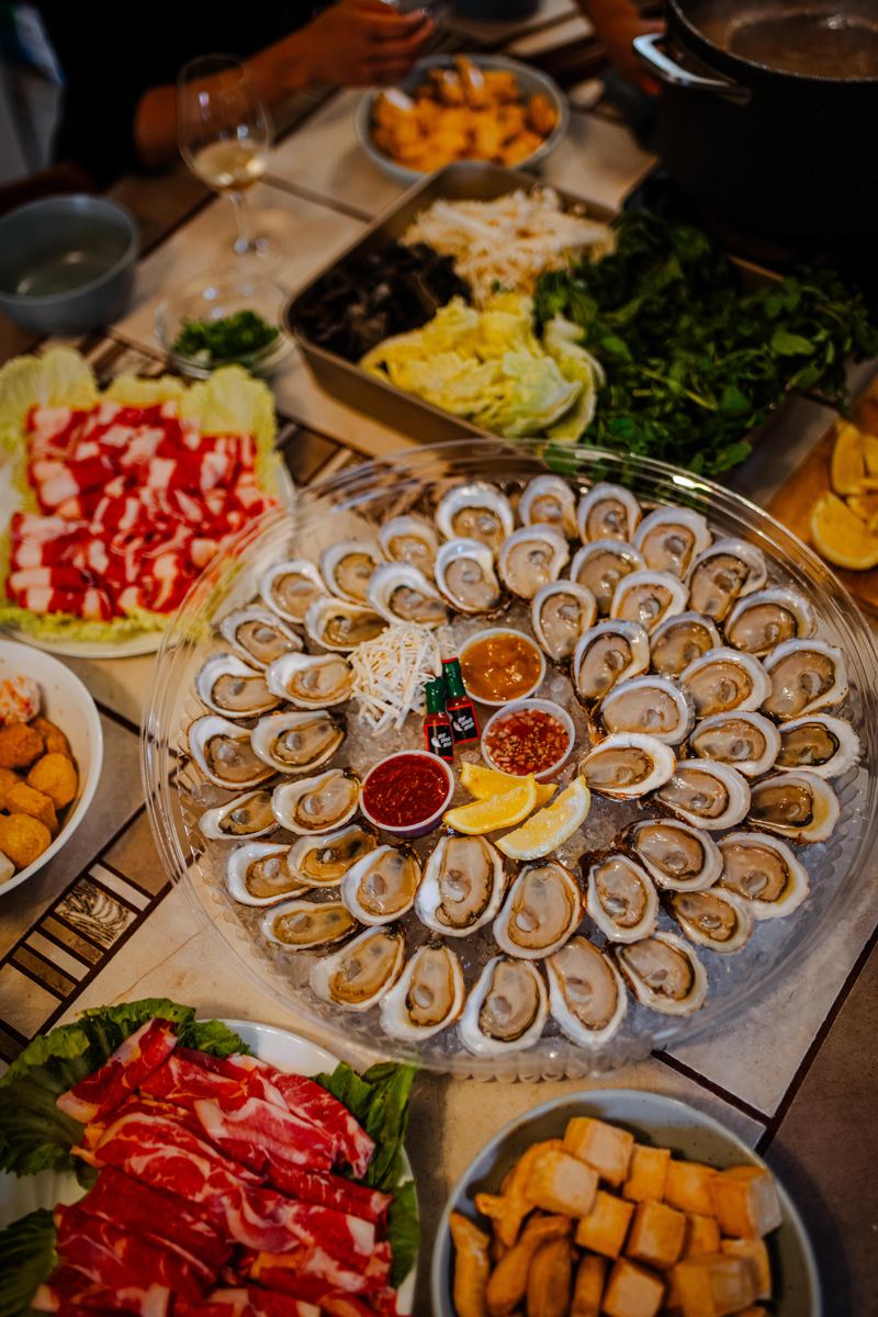 The platter on the table with greens and sides behind