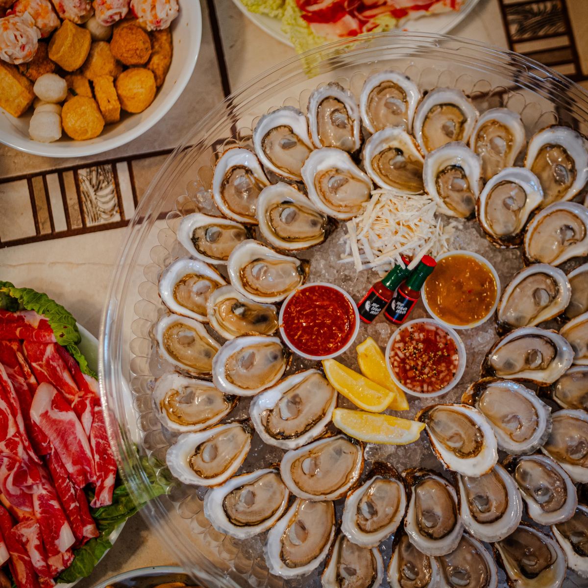 Overhead close-up of the platter with three sauces, lemon and horseradish